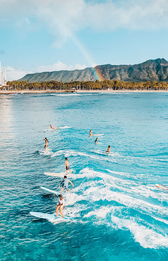 a group of people surfing in the water