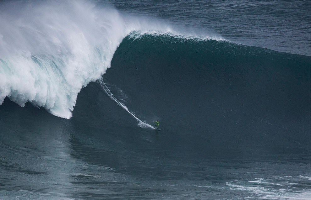 a person surfing on a large wave