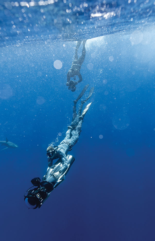 a group of people swimming underwater