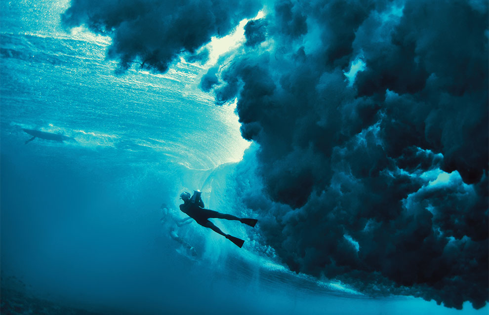 a group of people under a wave