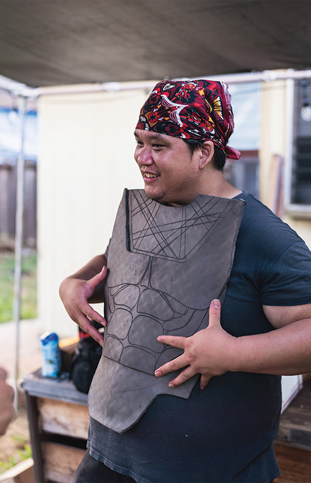 a person crafting a chest plate for a costume