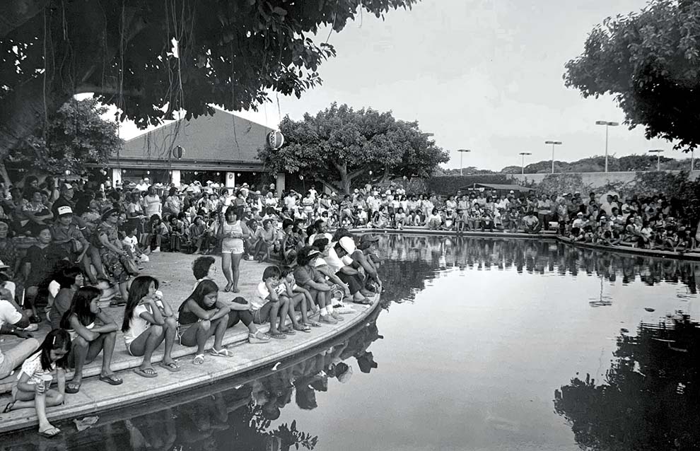 an old photograph of a river with people walking alongside