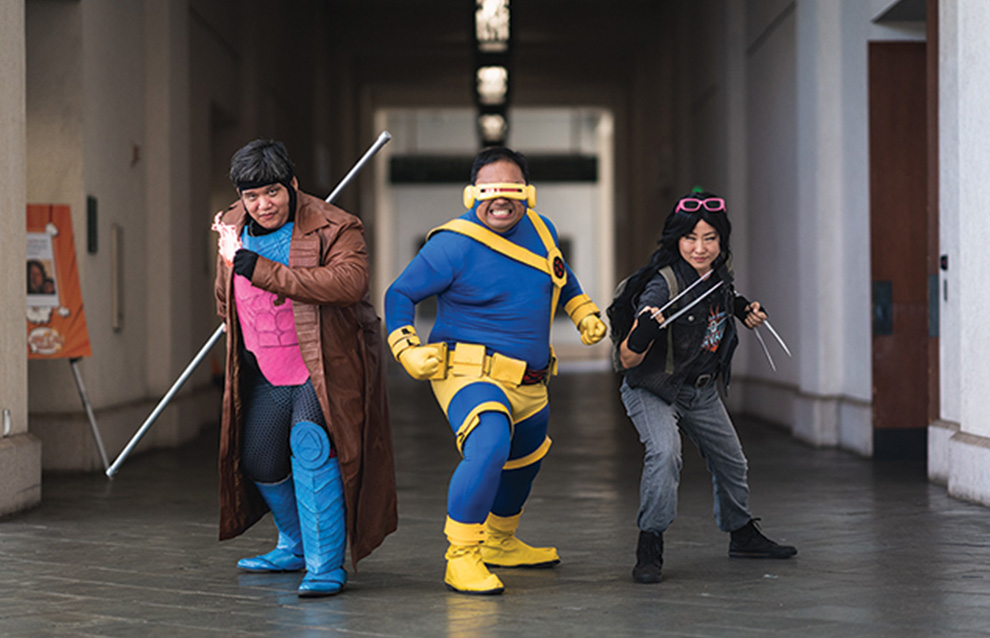 three people pose in costume