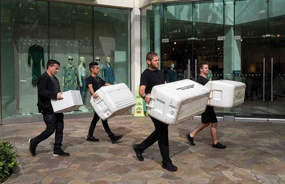 a group of people carrying coolers 